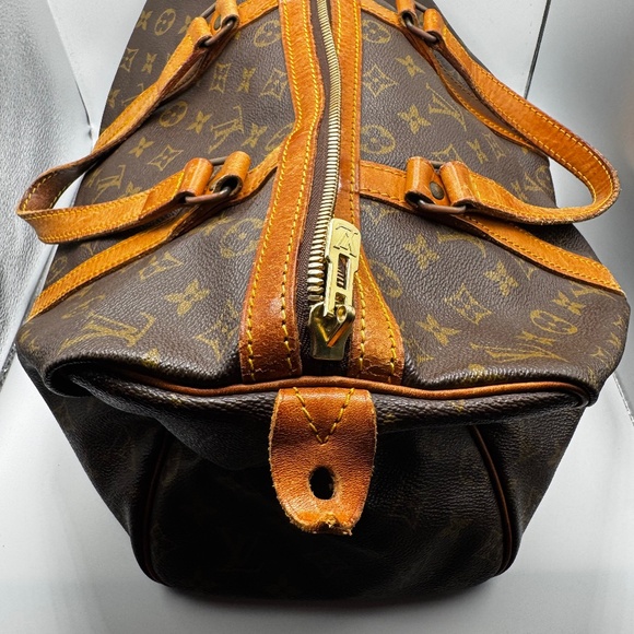 This is a Louis Vuitton Monogram Sac Souple travel bag. - Picture 1 of 5